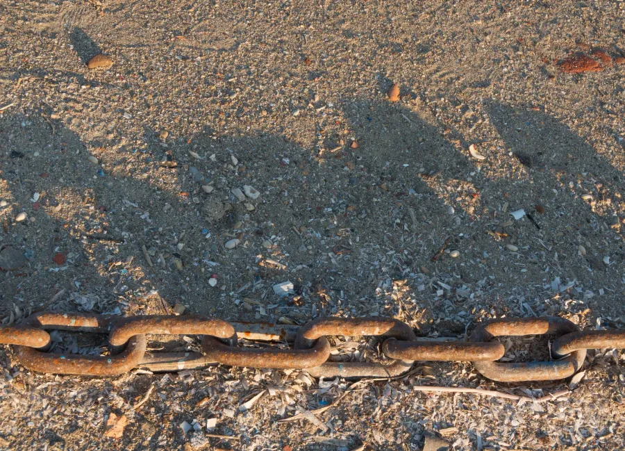 Close-up detail of anchor chain links showing the perpendicular crossbars and geometric construction
