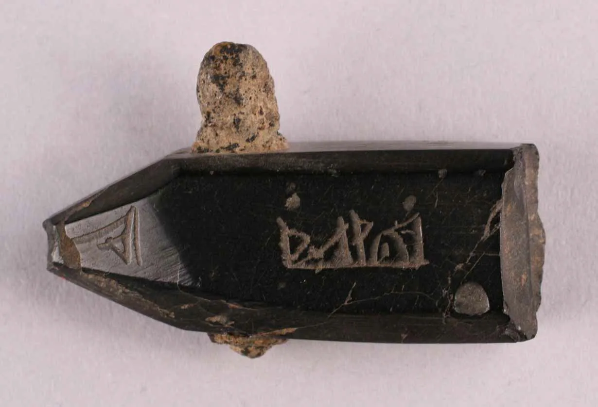 Black jet pendant carved with an Arabic inscription