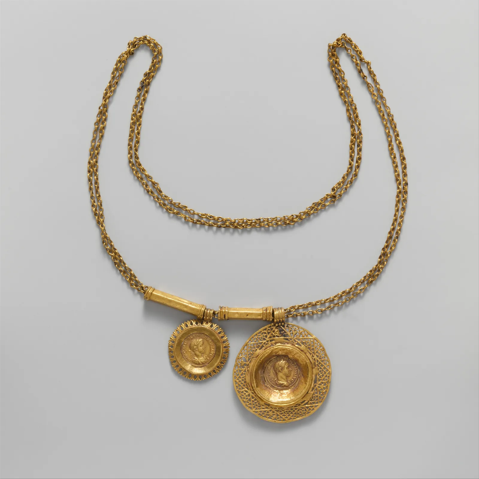 Collar romano de oro de doble cadena con dos colgantes circulares que llevan retratos de perfil