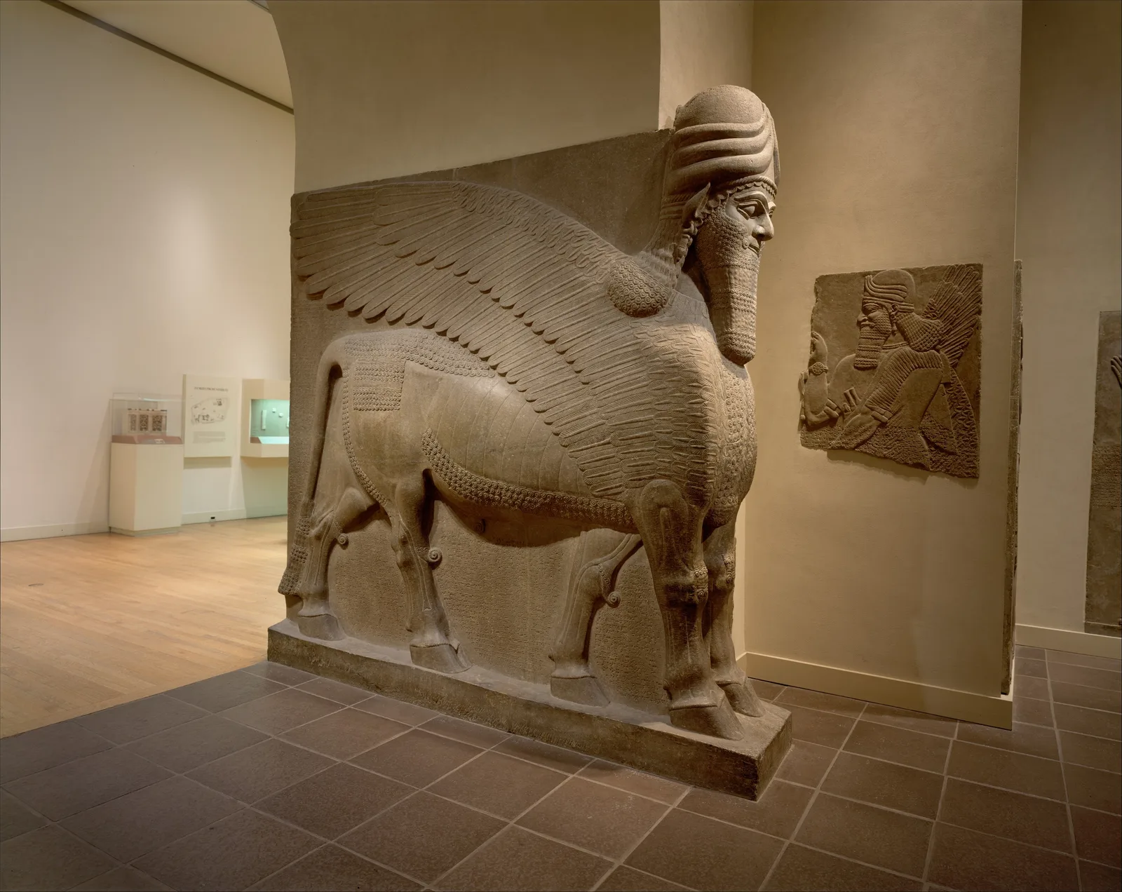 Assyrian lamassu: a winged bull with a human head, a relief from a palace