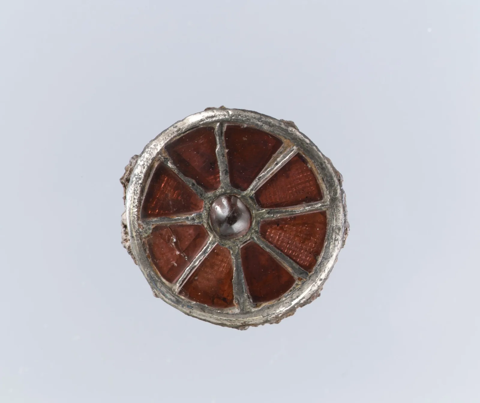 A round Frankish silver disc brooch with concentric ornament, sixth century