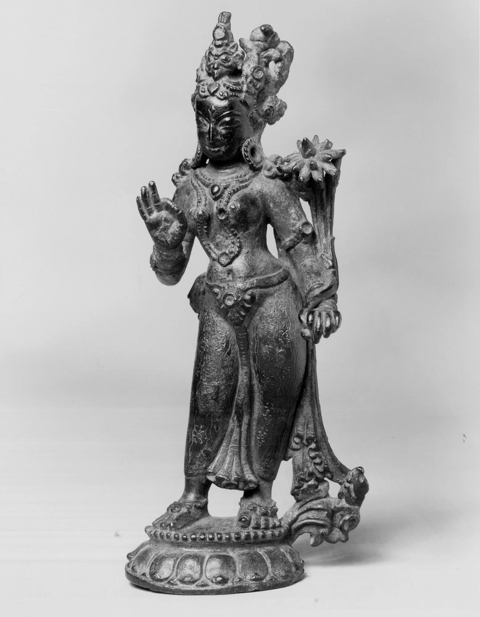 Figure of a standing goddess in copper alloy inlaid with semiprecious stones, warm golden metal sheen, 13th century, Kathmandu Valley