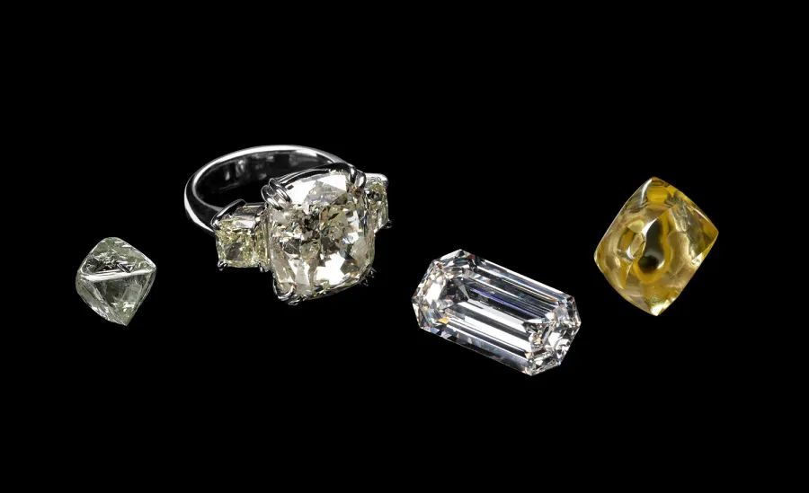 Four large American diamonds from the Smithsonian Institution collection: an uncut crystal, a colorless stone, a yellow crystal, and a faceted brilliant