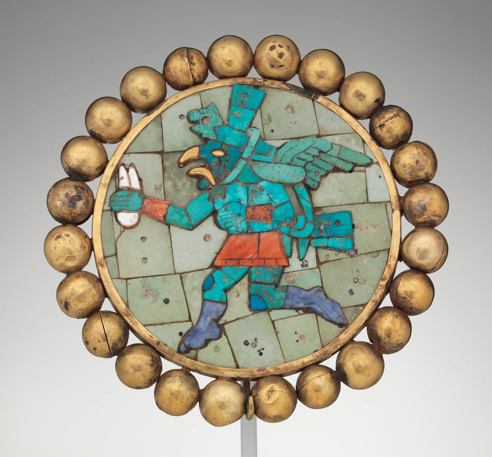 Ancient Moche gold ear ornament inlaid with turquoise