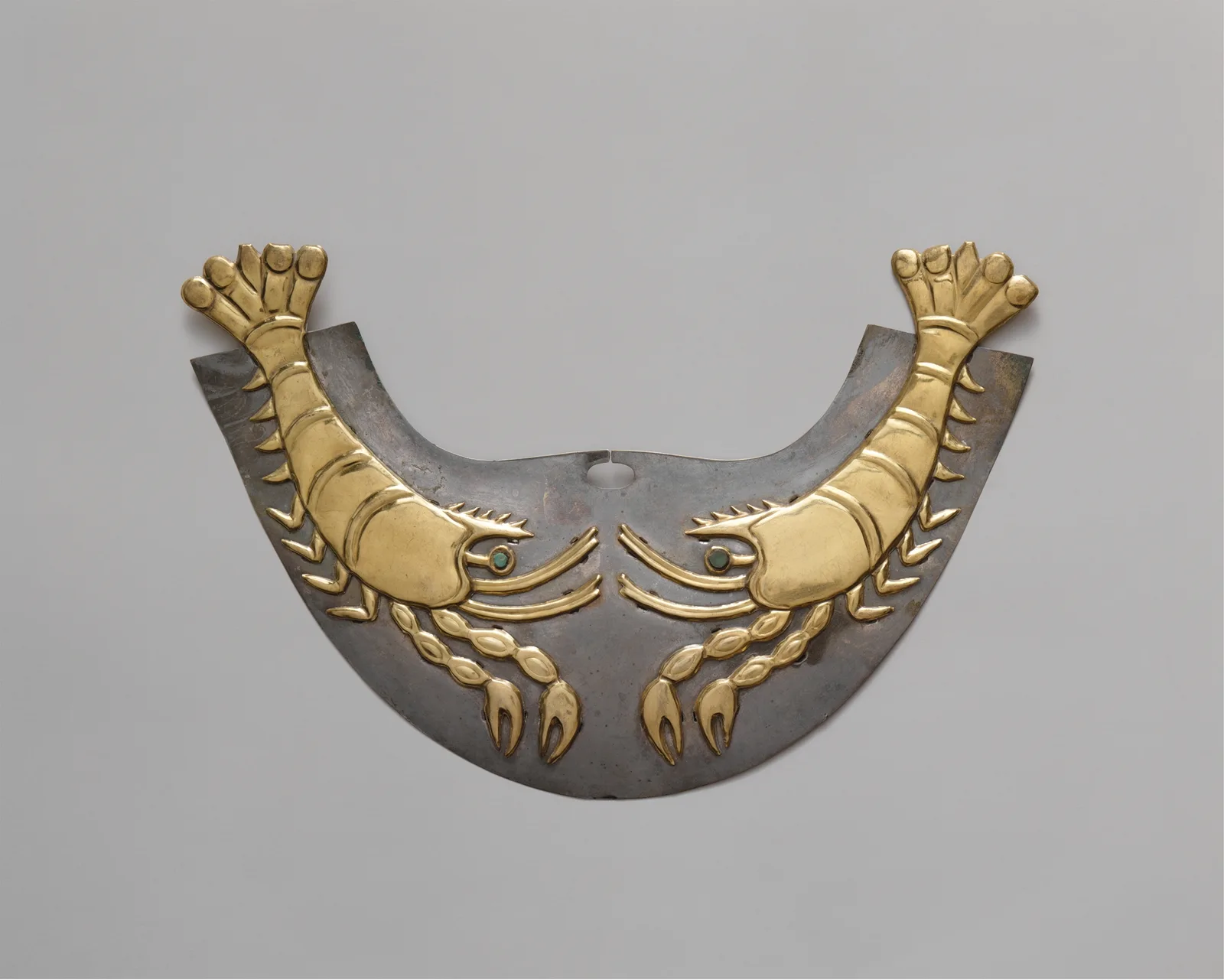 Moche gold nose ornament in the shape of a shrimp